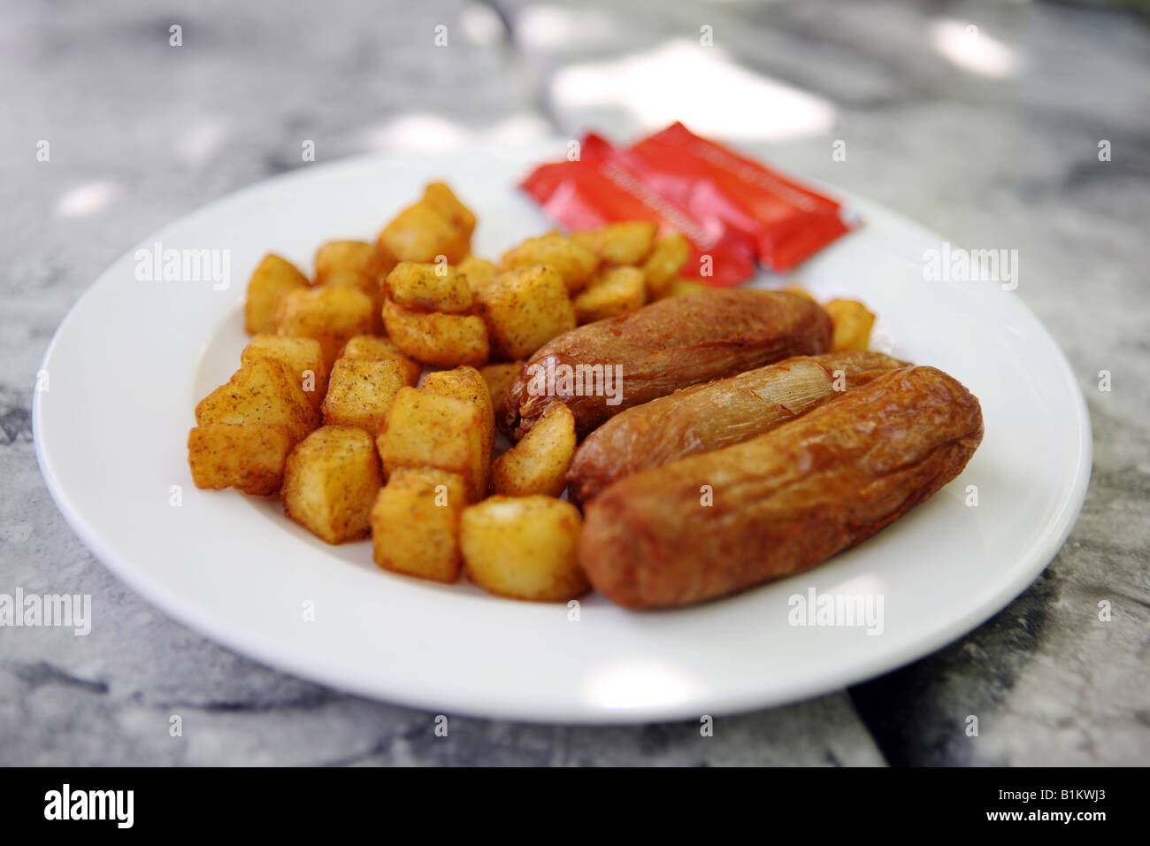 Sausage & roast potatoes Stock Photo - Alamy
