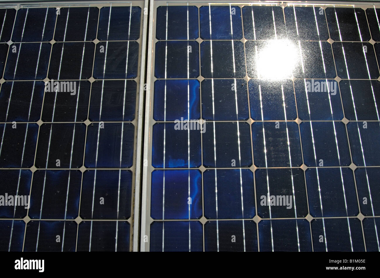 Sun reflected in solar panels Stock Photo