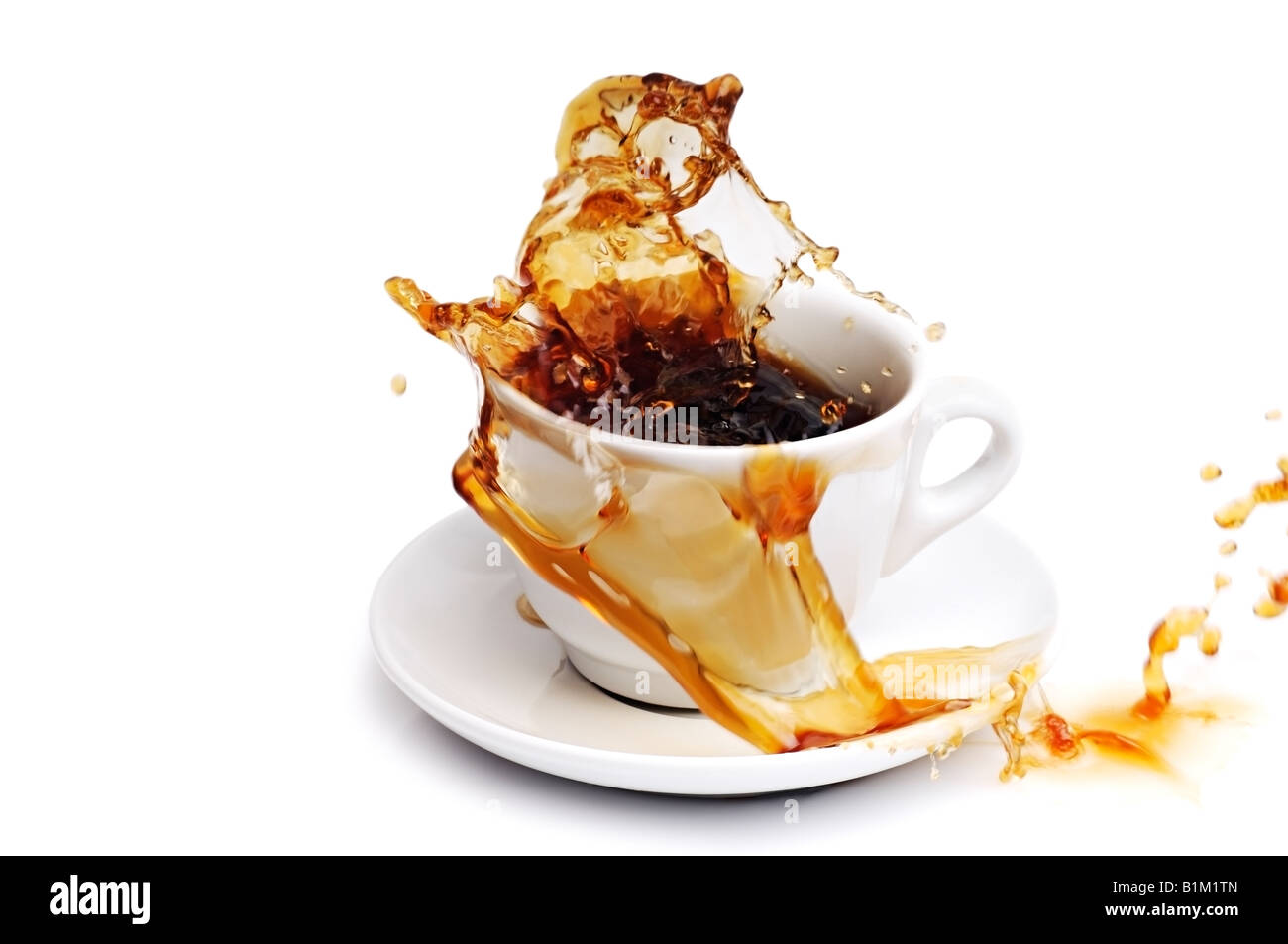 Coffee Spilling from a Cup Against a White Background Stock Photo