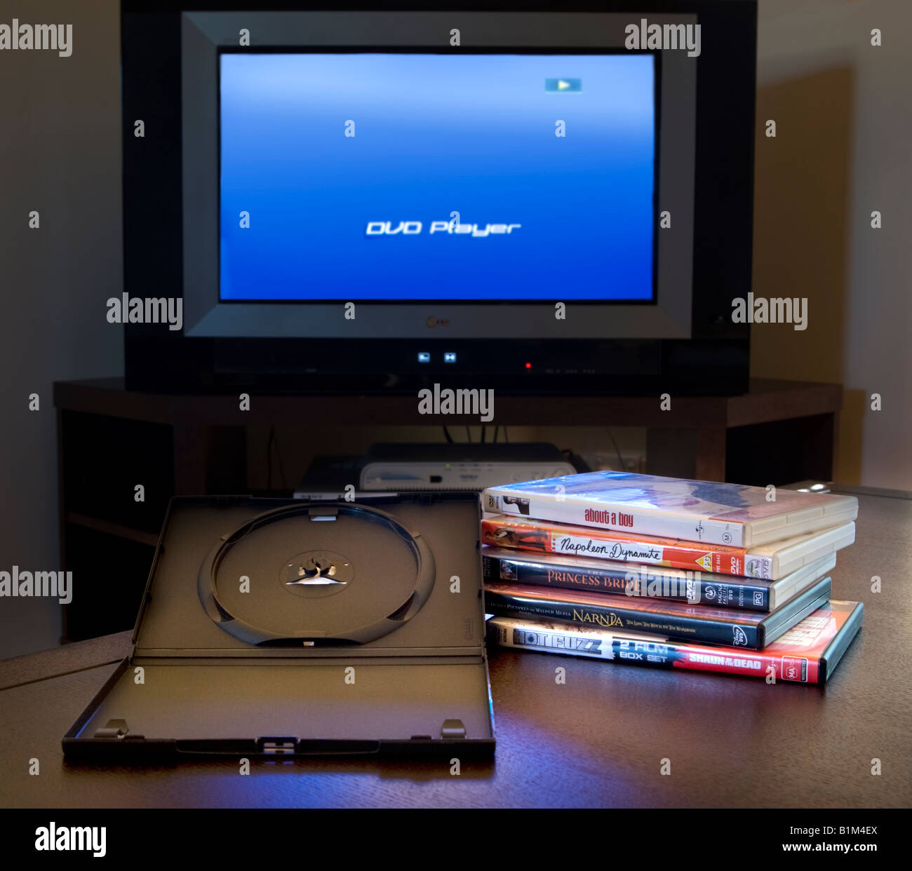 A pile of DVD films ready for a movie marathon, with a television and DVD  player in the background Stock Photo - Alamy