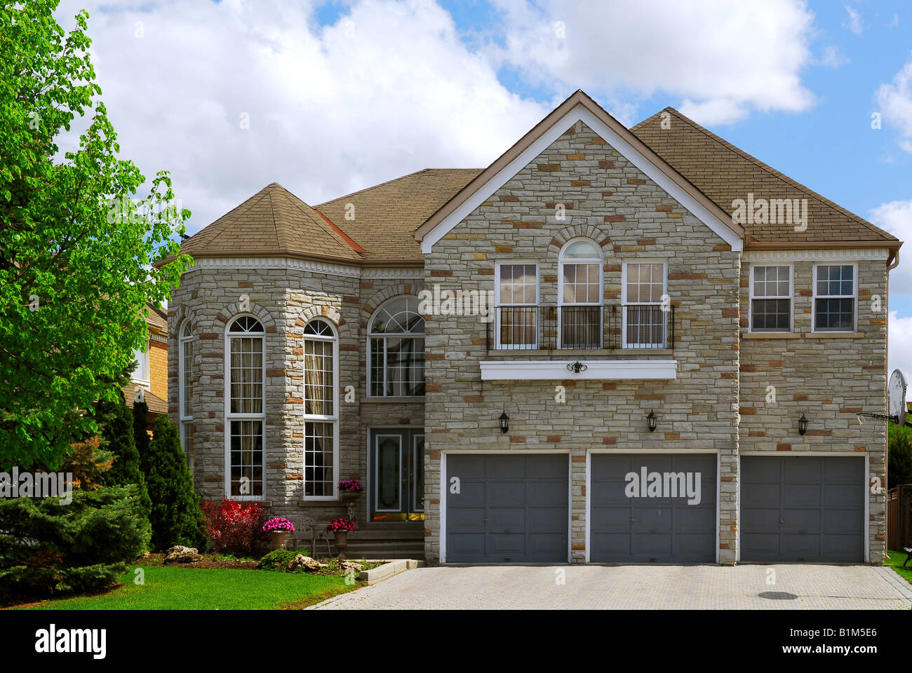 Big luxury residential house with natural stone facing Stock Photo