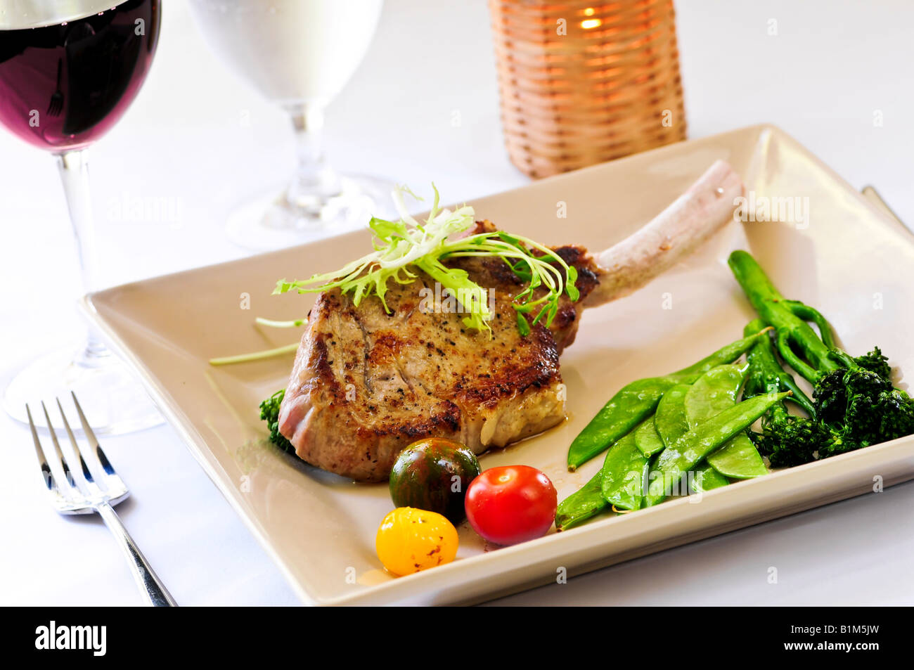 Gourmet dinner of veal rib chop and vegetables Stock Photo Alamy