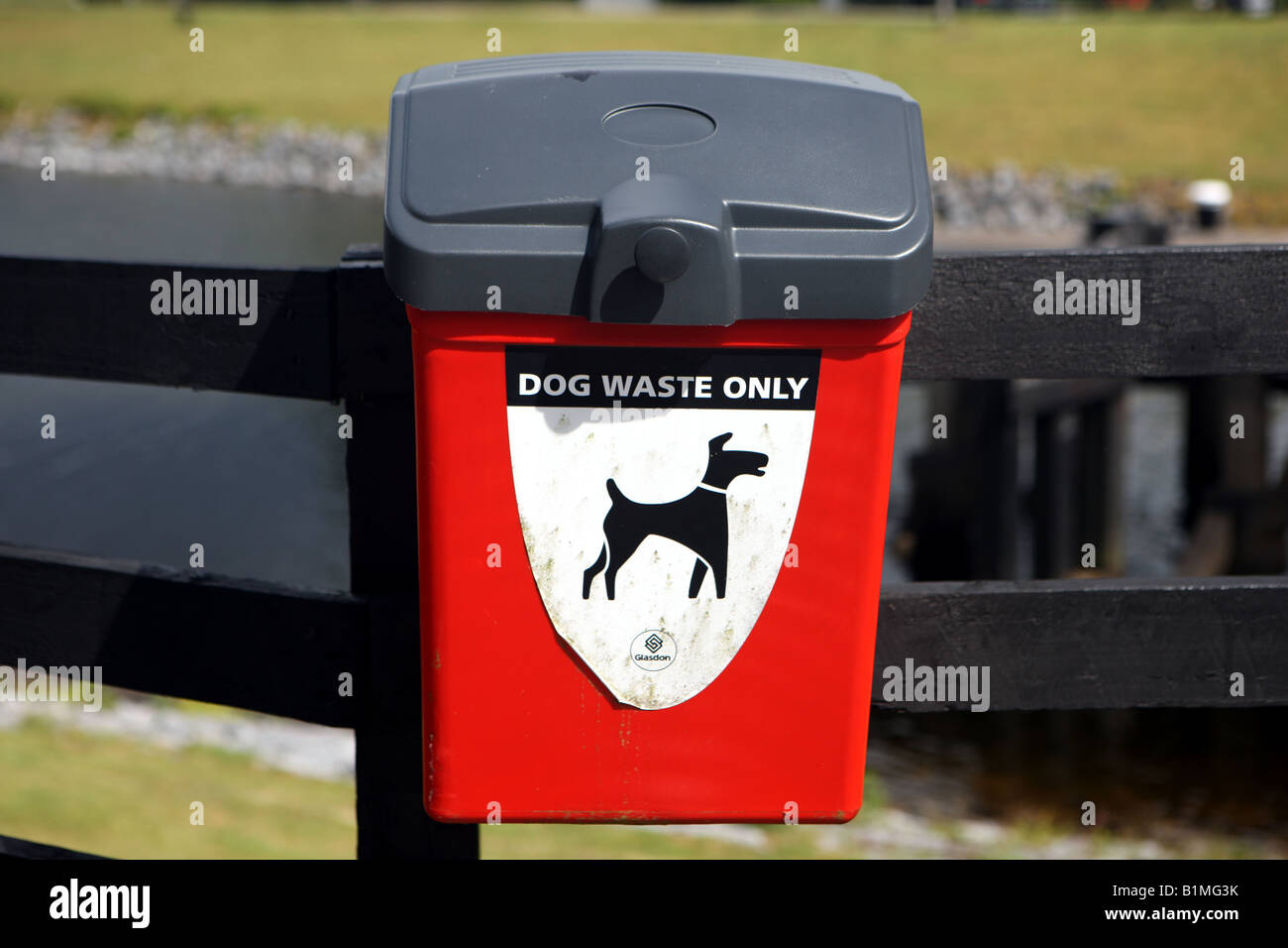 Red dog litter bin Stock Photo Alamy