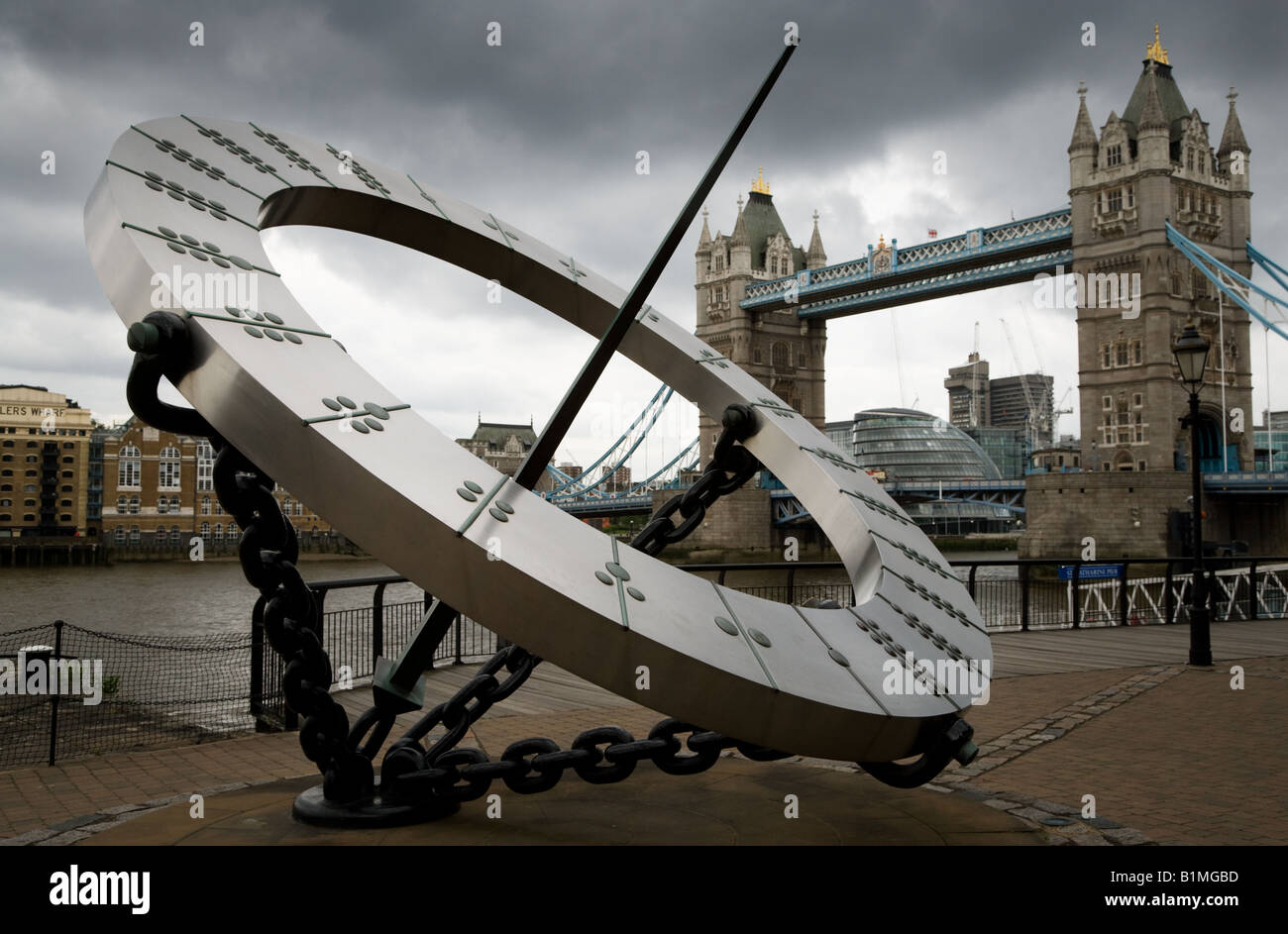 The timepiece sculpture is a famous London landmark with Tower Bridge in the background Stock Photo