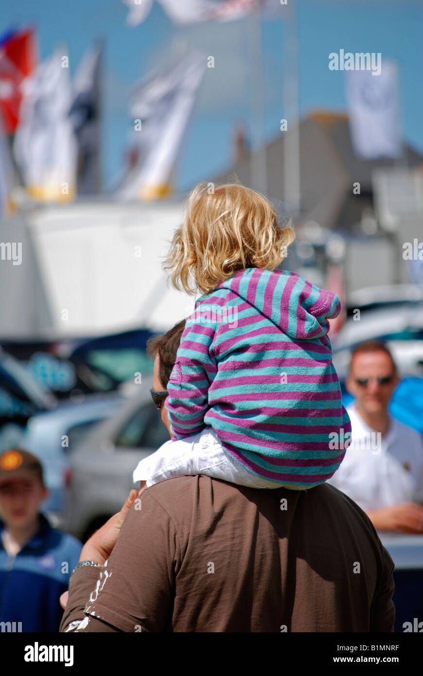 a small child on fathers shoulders Stock Photo