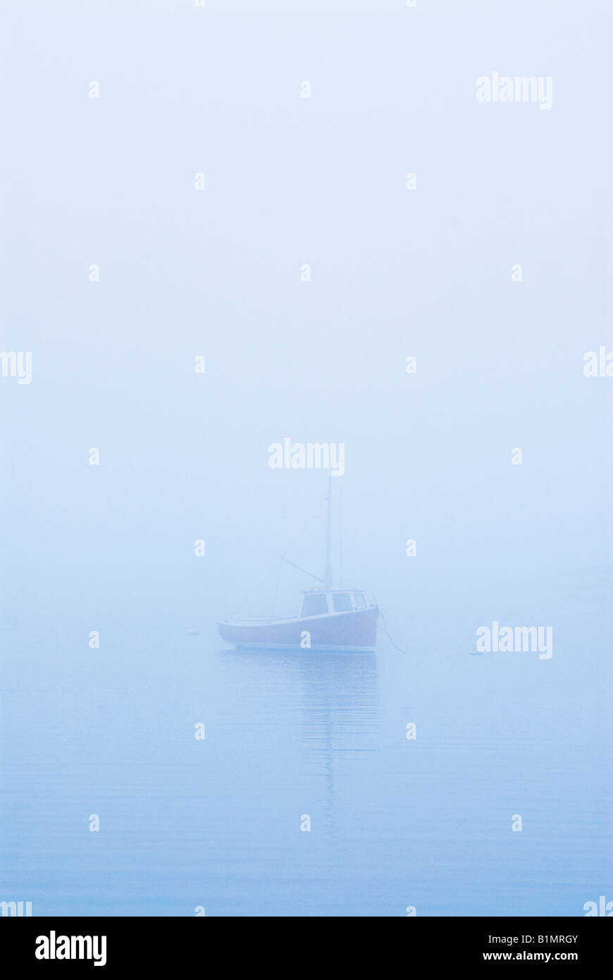Fishing boat in fog Stock Photo