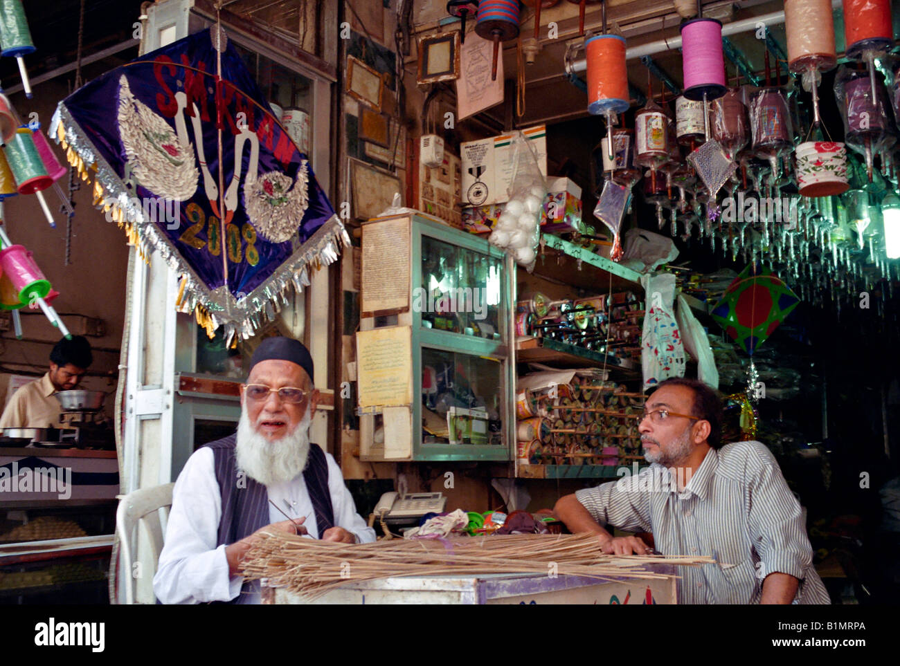 INDIA MUMBAI MAHARASHTRA Elderly kite maker making kites in his tiny