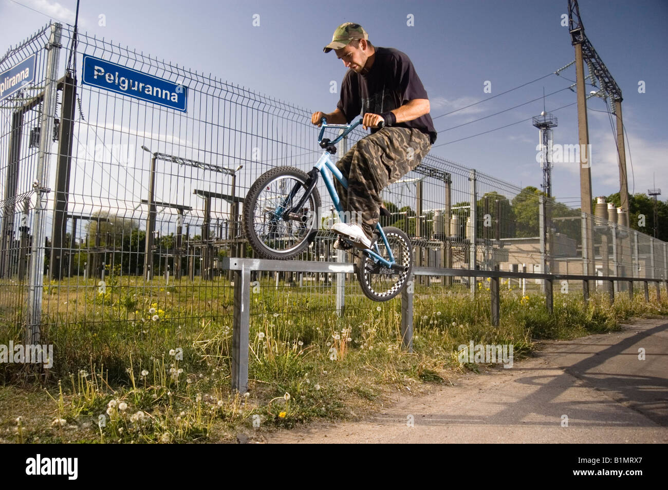 BMX rider doing "Feeble grind" on a rail Stock Photo - Alamy