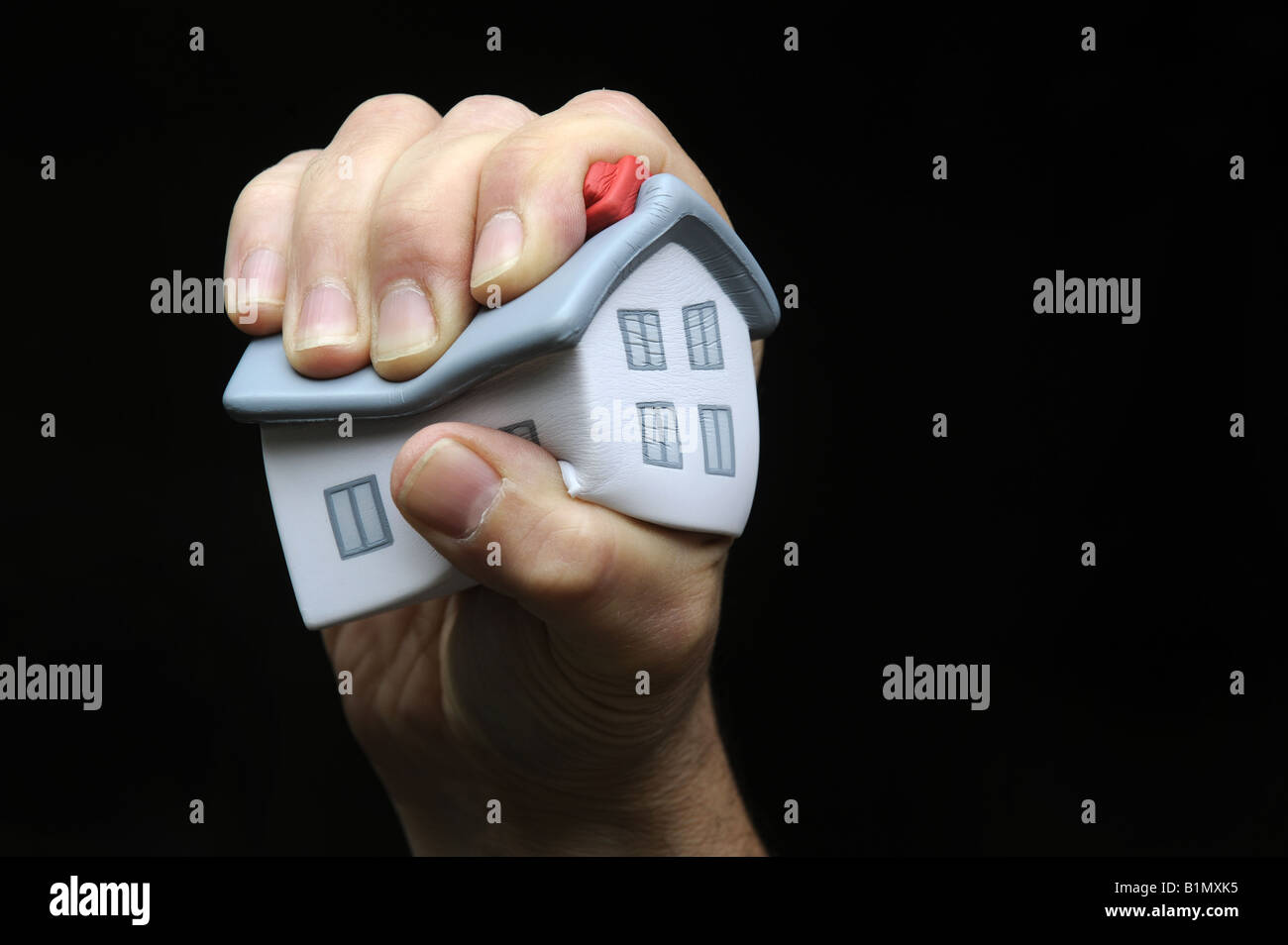 MODEL HOUSE HELD IN A MANS HAND RE PROPERTY MARKETS RISING PRICES MORTGAGES ECONOMY ETC,UK. Stock Photo