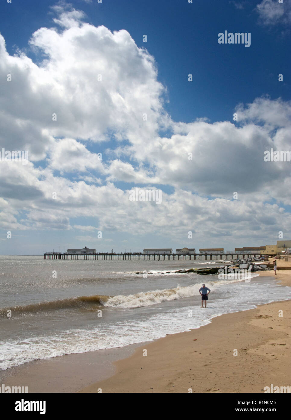 A man paddles in the north sea at Southwold, Suffolk Stock Photo