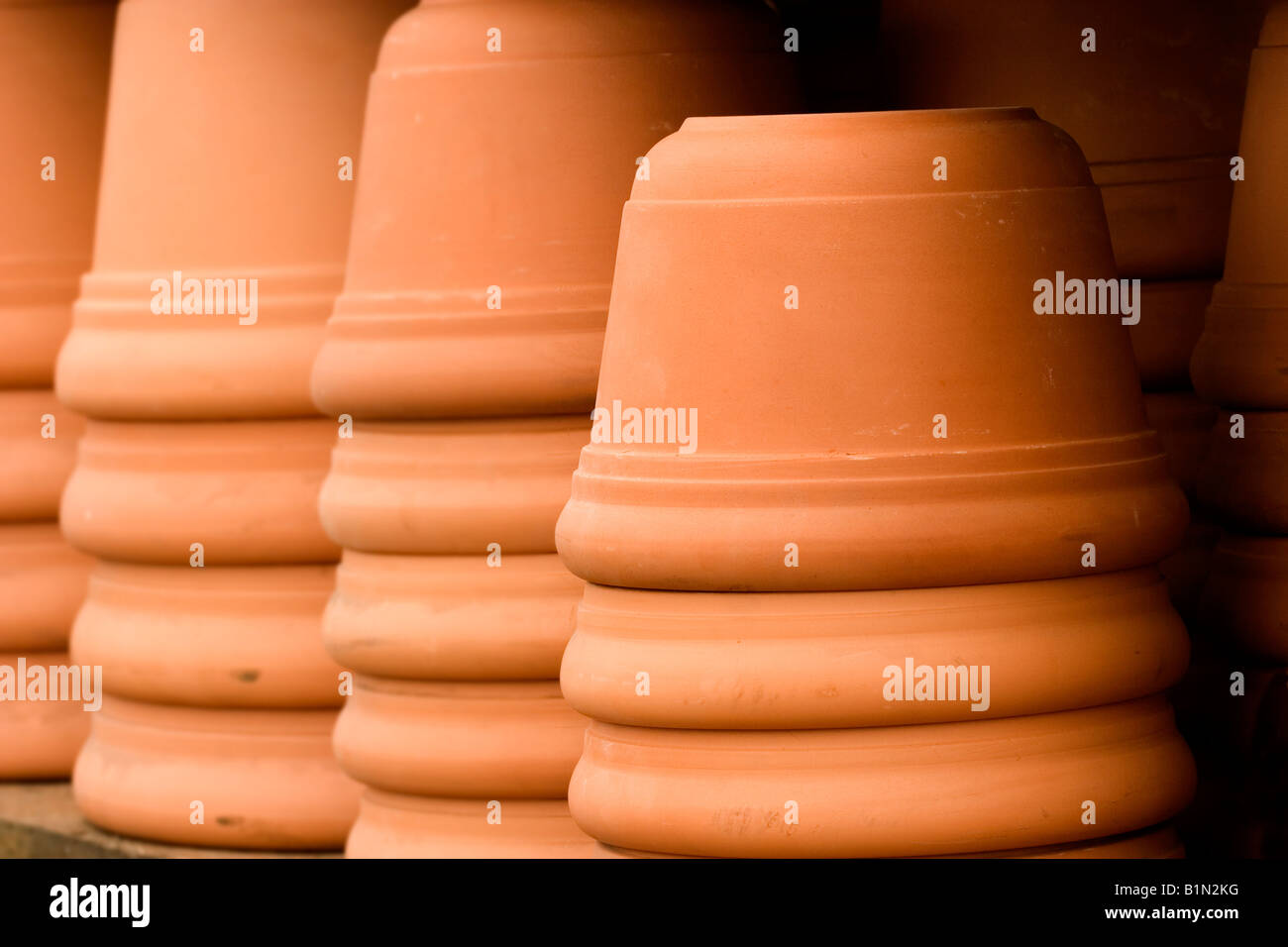 Stacks of clay flower pots in a garden center Stock Photo