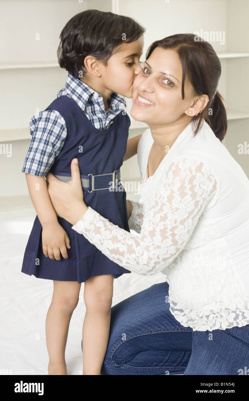 Side profile of a girl kissing her mother Stock Photo