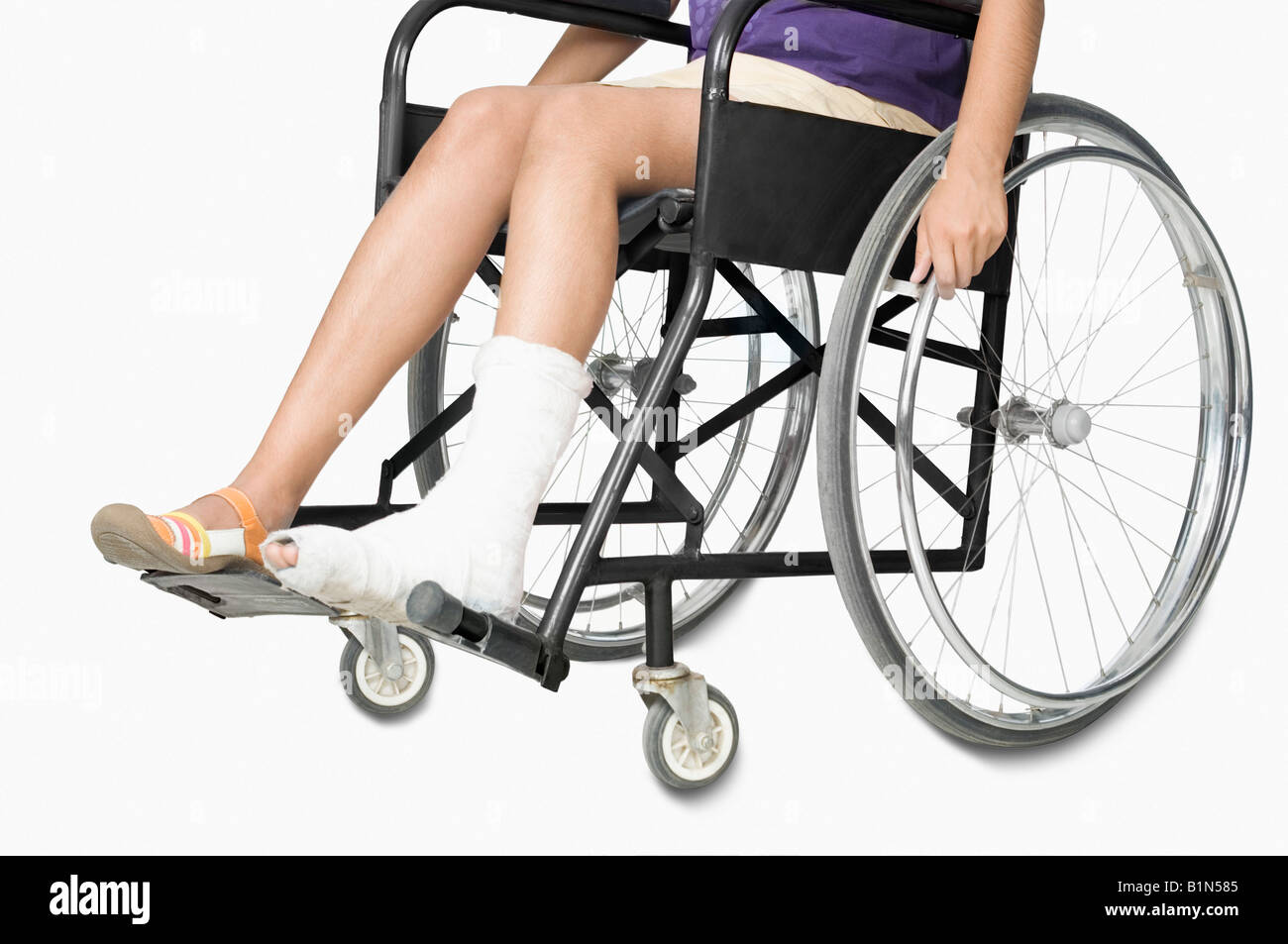 Low section view of a girl sitting in a wheelchair Stock Photo - Alamy