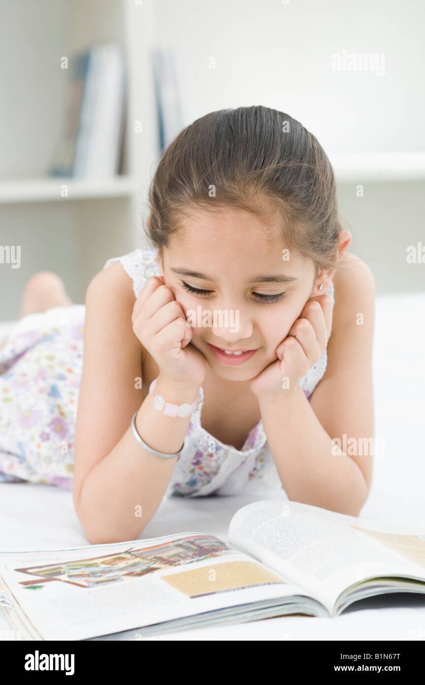 Indian girl reading book bed hi-res stock photography and images - Alamy