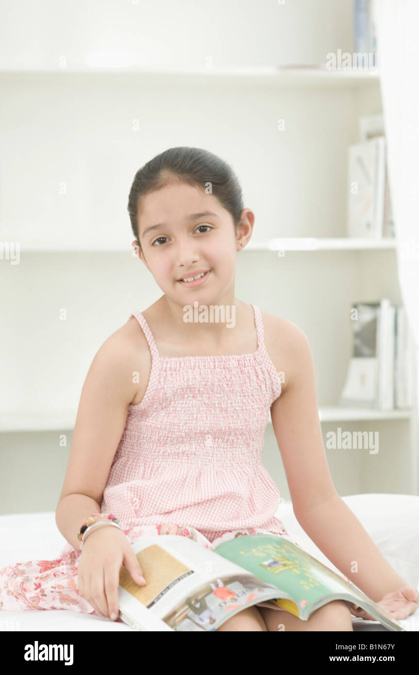 Indian girl reading book bed hi-res stock photography and images - Alamy
