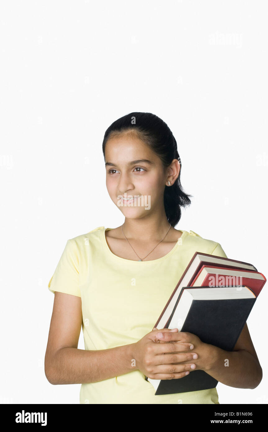 Teenage girl holding books Stock Photo - Alamy