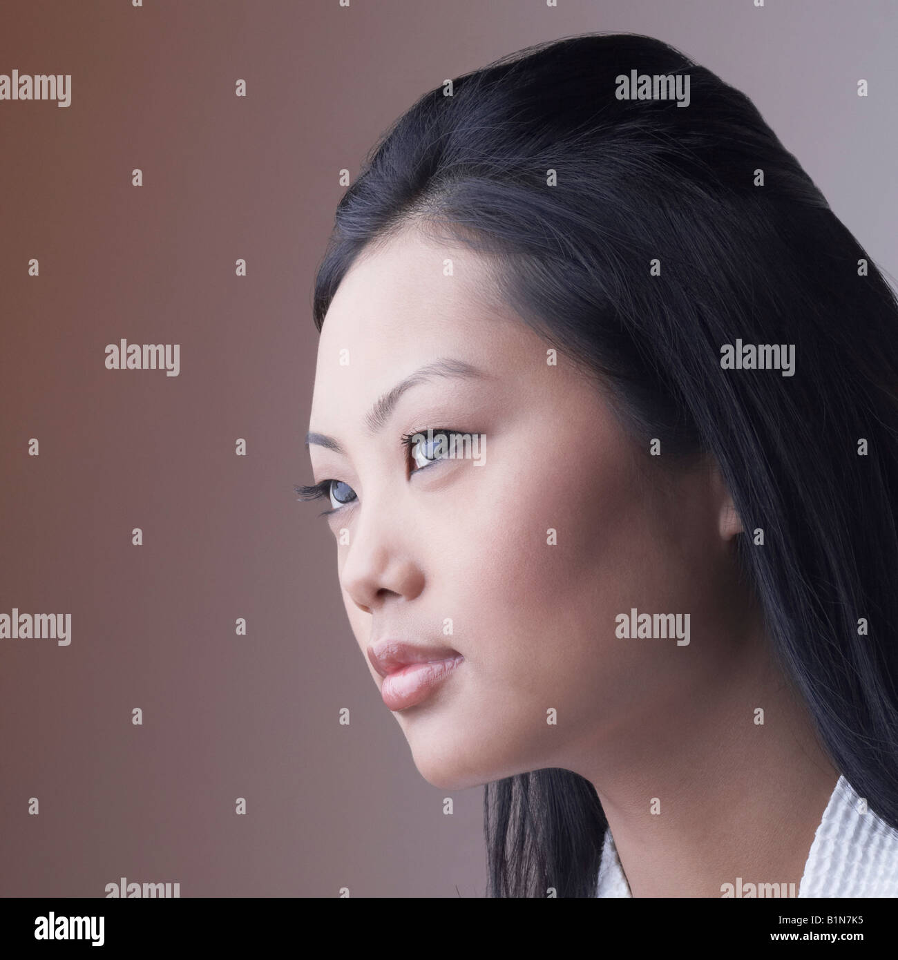 Close-up of a young woman looking away Stock Photo - Alamy
