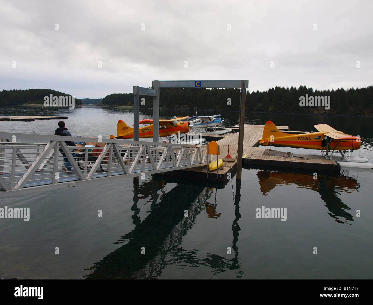 Three DeHavilland float planes tied up to seaplane dock in Kodiak ...