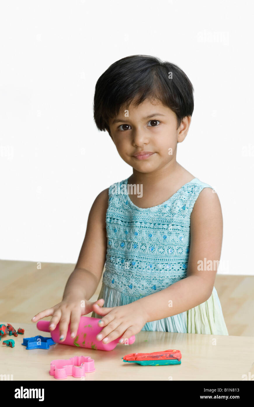 Portrait of a girl playing with toys Stock Photo - Alamy