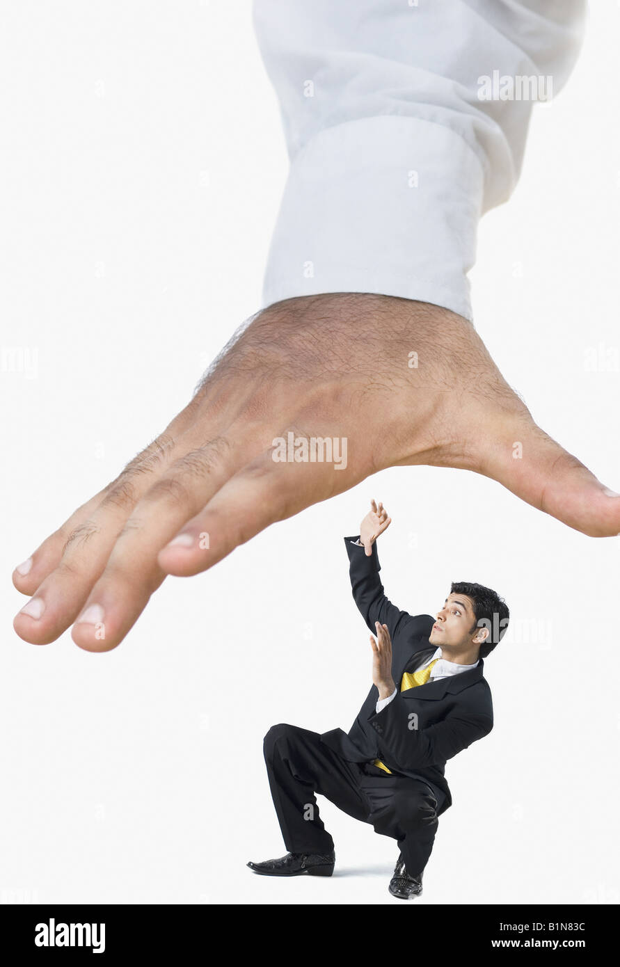 Businessman being crushed under human hires stock photography and