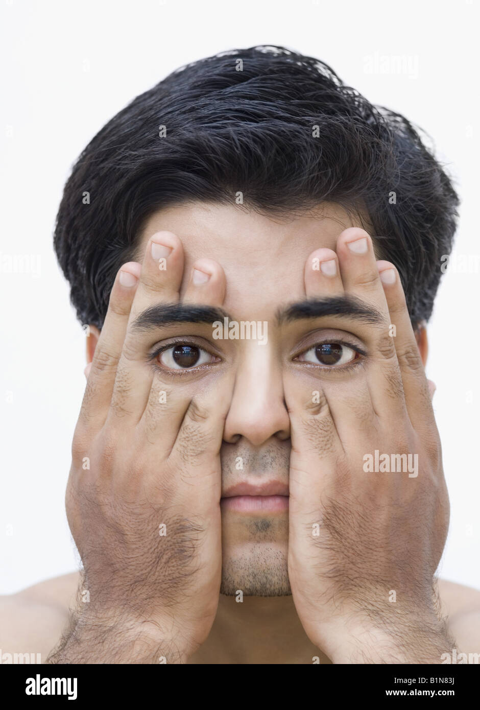 Portrait of a young man covering his eyes with his hands Stock Photo ...