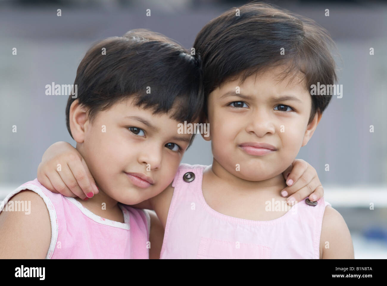 Portrait of two girls arm around each other Stock Photo - Alamy