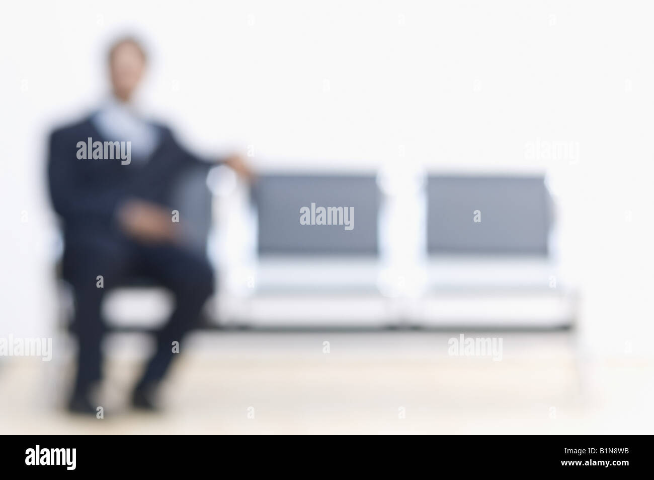 Businessman sitting on a bench Stock Photo - Alamy