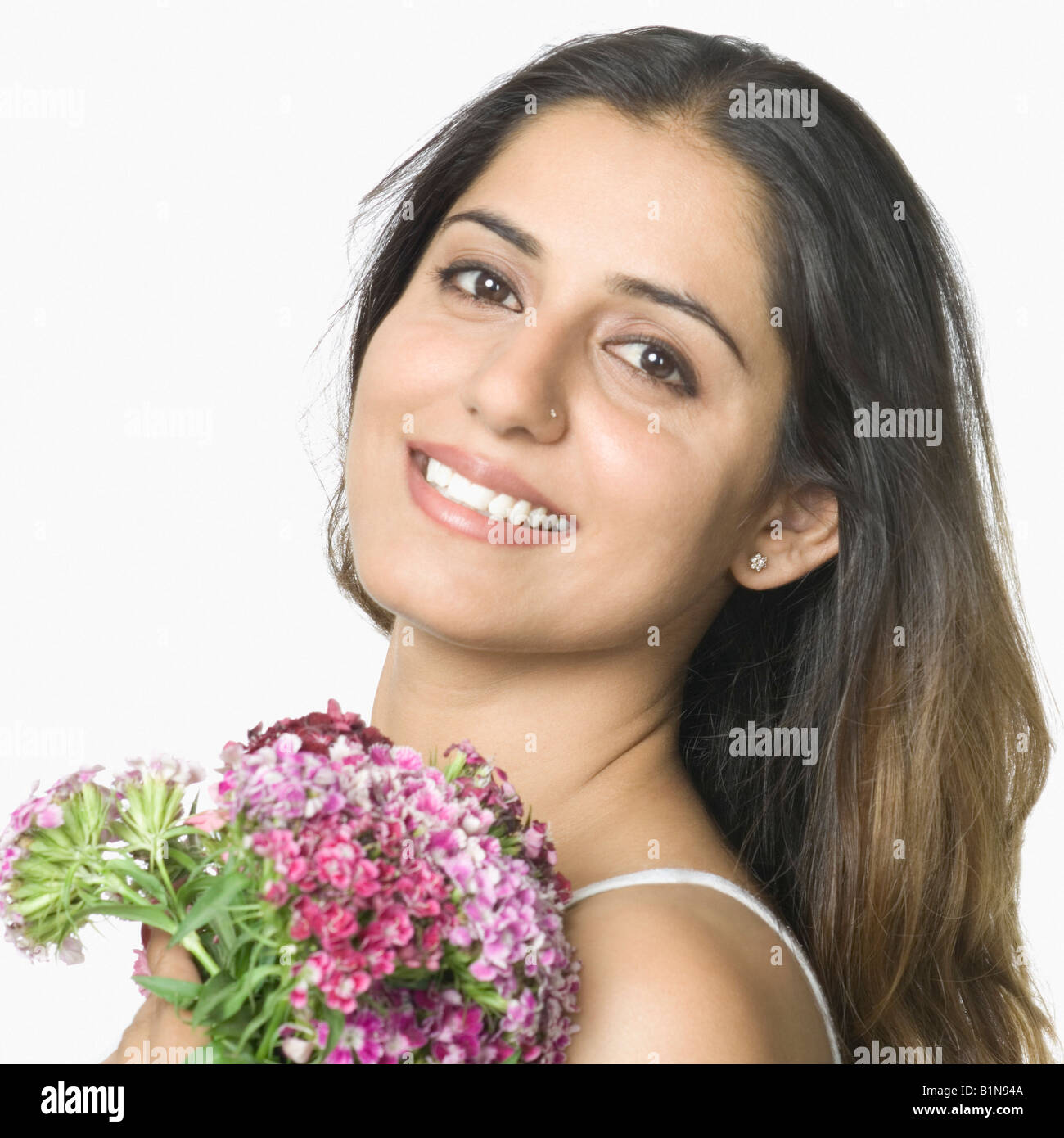 Portrait of a young woman holding a bunch of flowers and smiling Stock ...