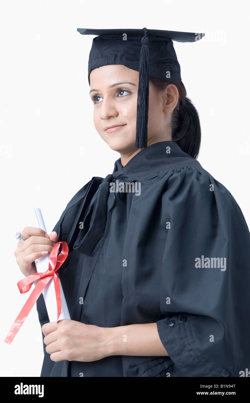 Young female graduate holding a diploma Stock Photo - Alamy
