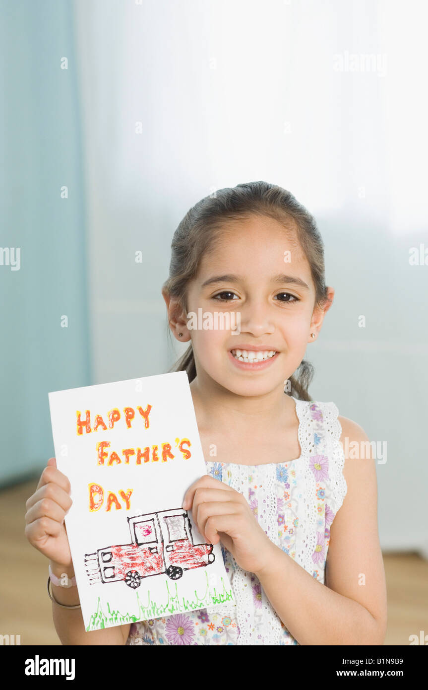 Portrait of a girl showing her drawing and smiling Stock Photo - Alamy