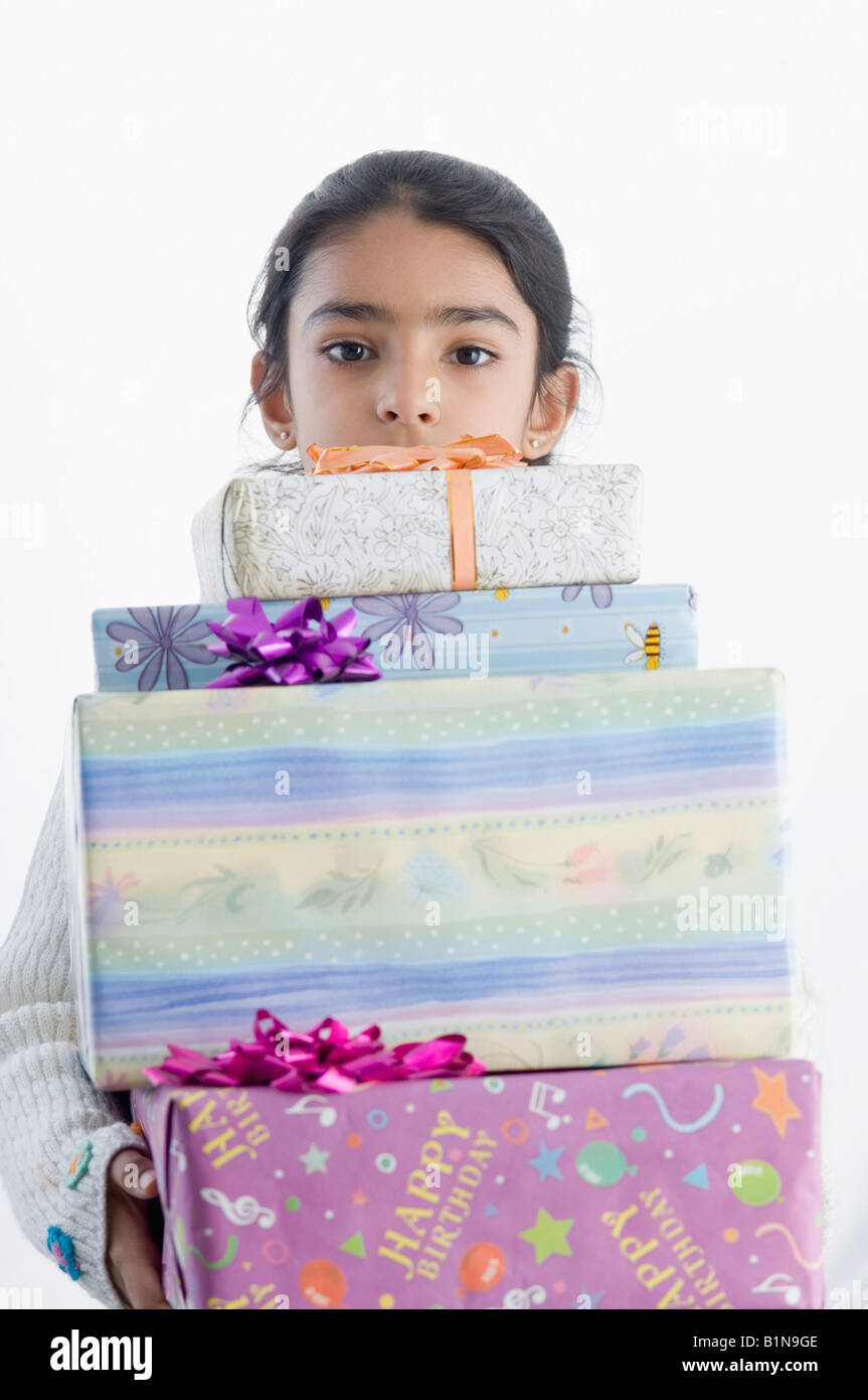 Portrait of a girl holding presents Stock Photo - Alamy