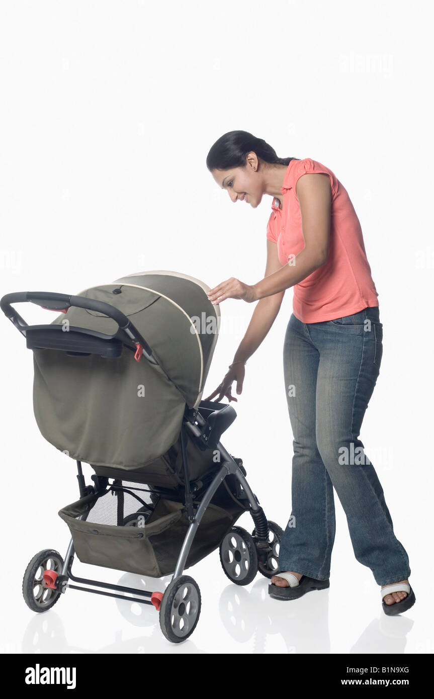 Mid adult woman holding a baby stroller Stock Photo