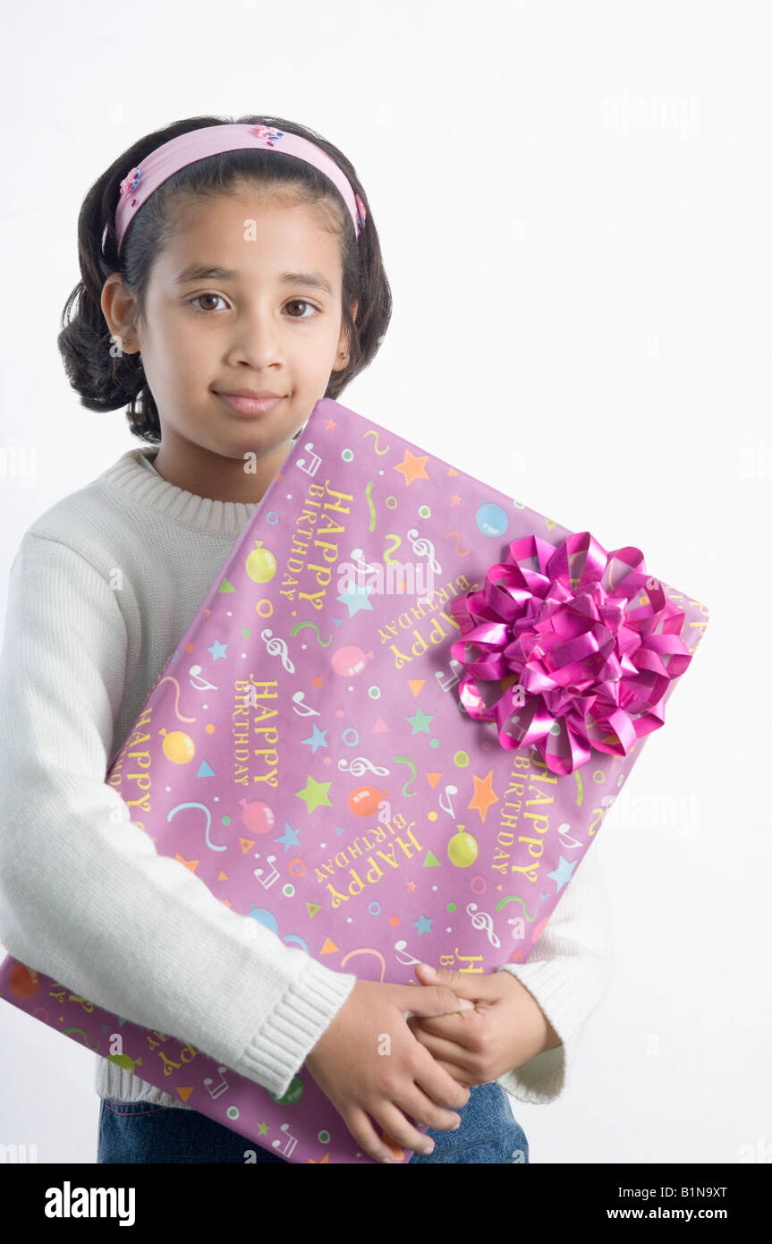 Portrait of a girl holding a present Stock Photo