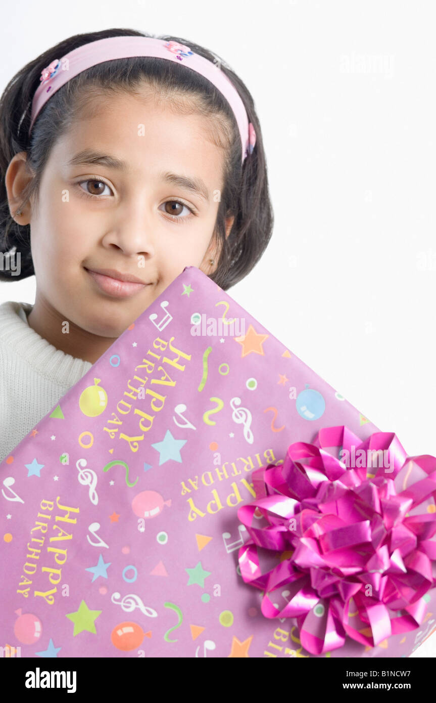 Portrait of a girl holding a present Stock Photo - Alamy