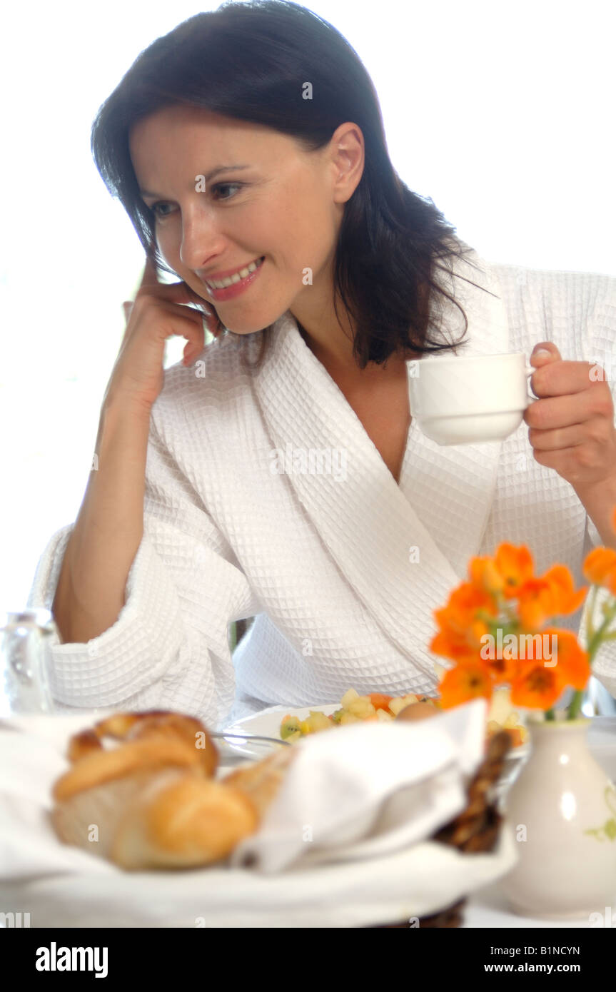 Woman wearing a bathrobe is having breakfast Stock Photo - Alamy