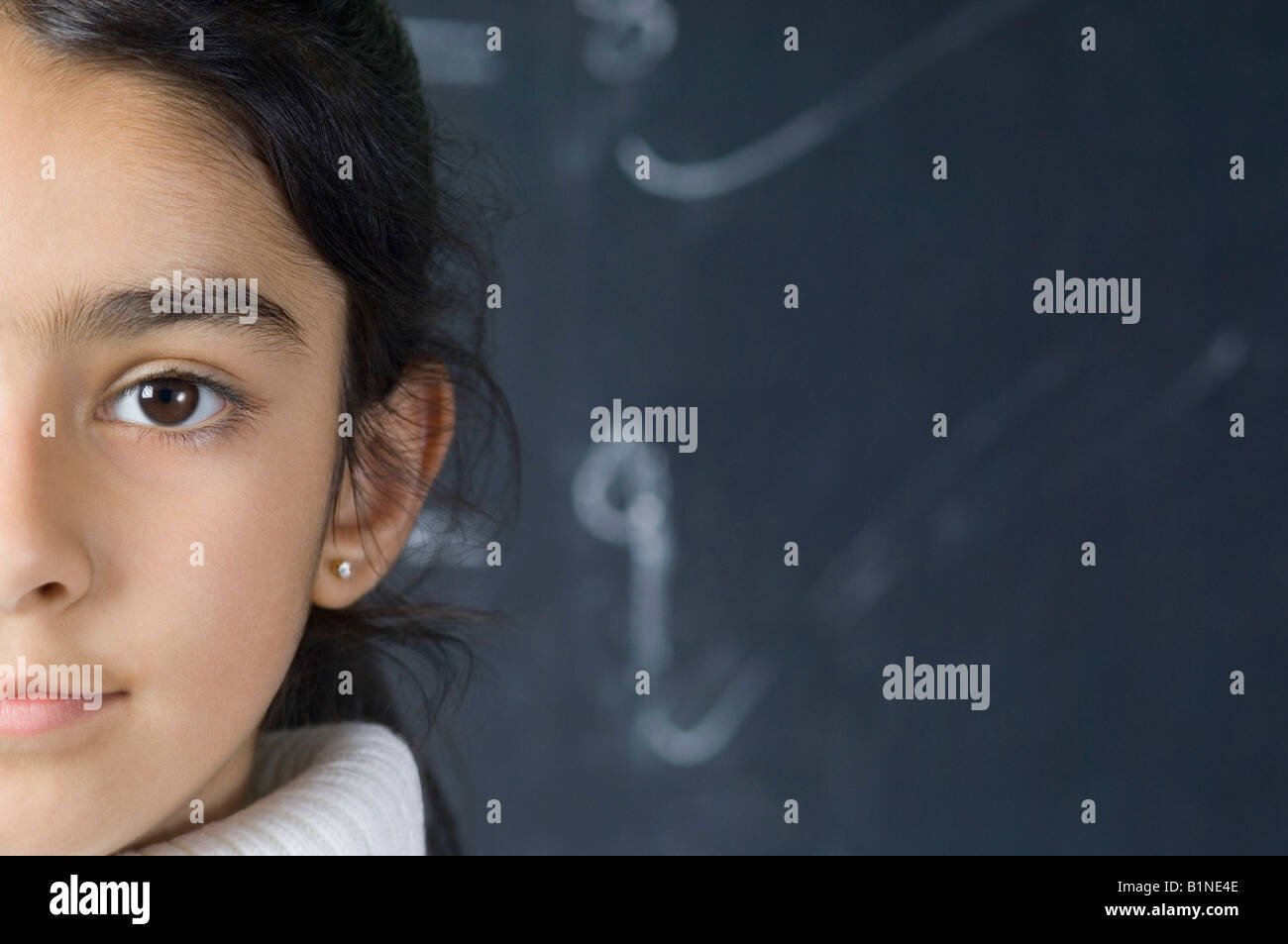 Portrait of a girl in front of a blackboard Stock Photo