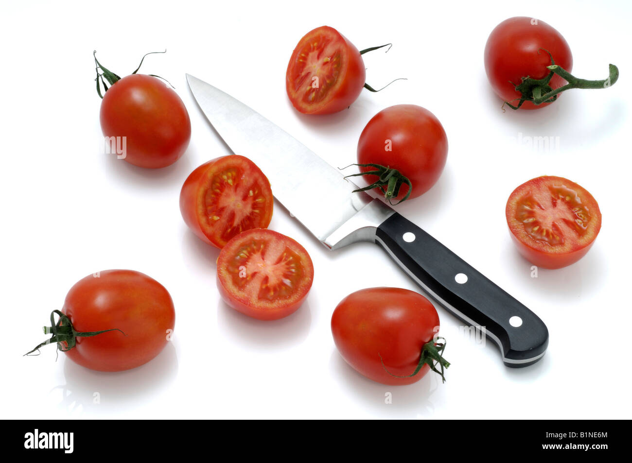Tomatoes and a knife Stock Photo - Alamy