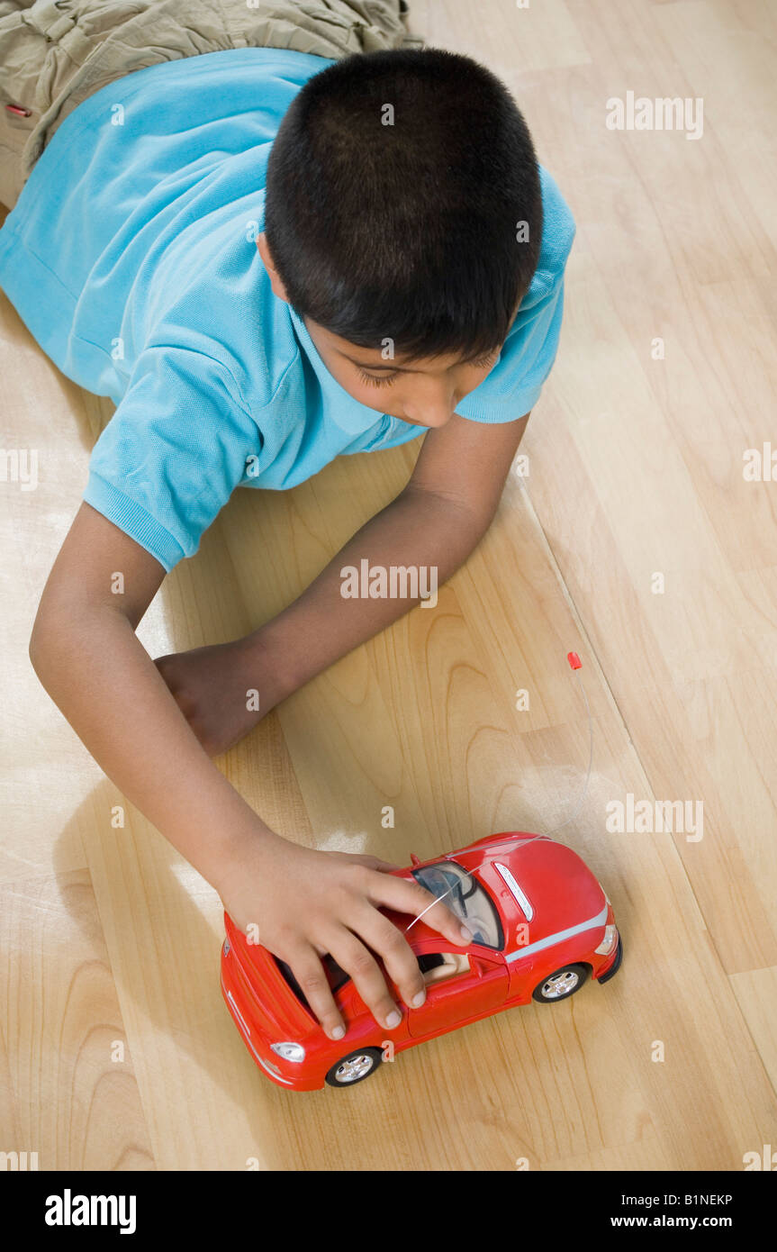 High angle view of a boy playing with a toy car Stock Photo - Alamy