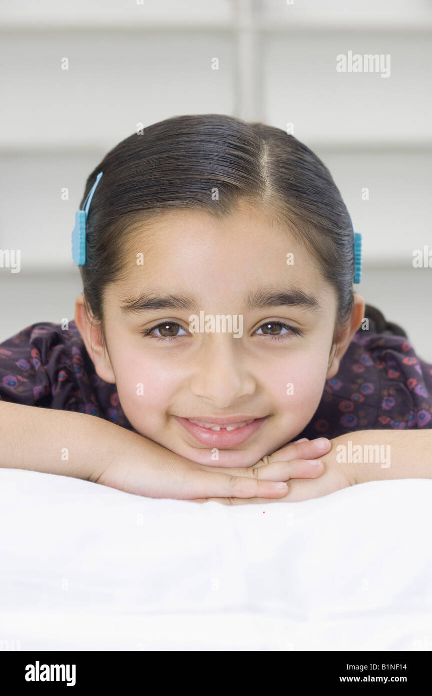 Portrait of a girl lying on the bed and smiling Stock Photo - Alamy