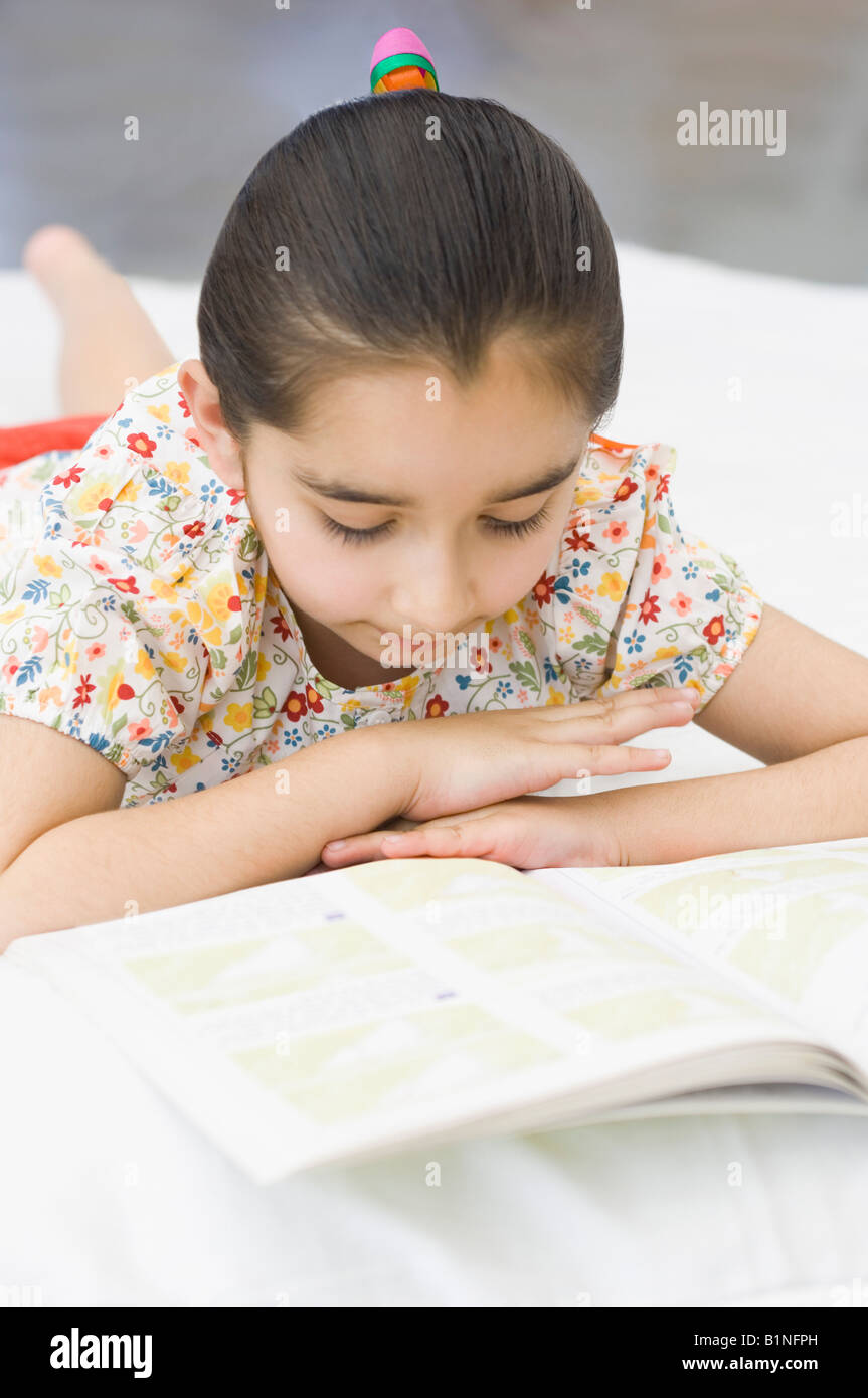 Indian girl reading book bed hi-res stock photography and images - Alamy