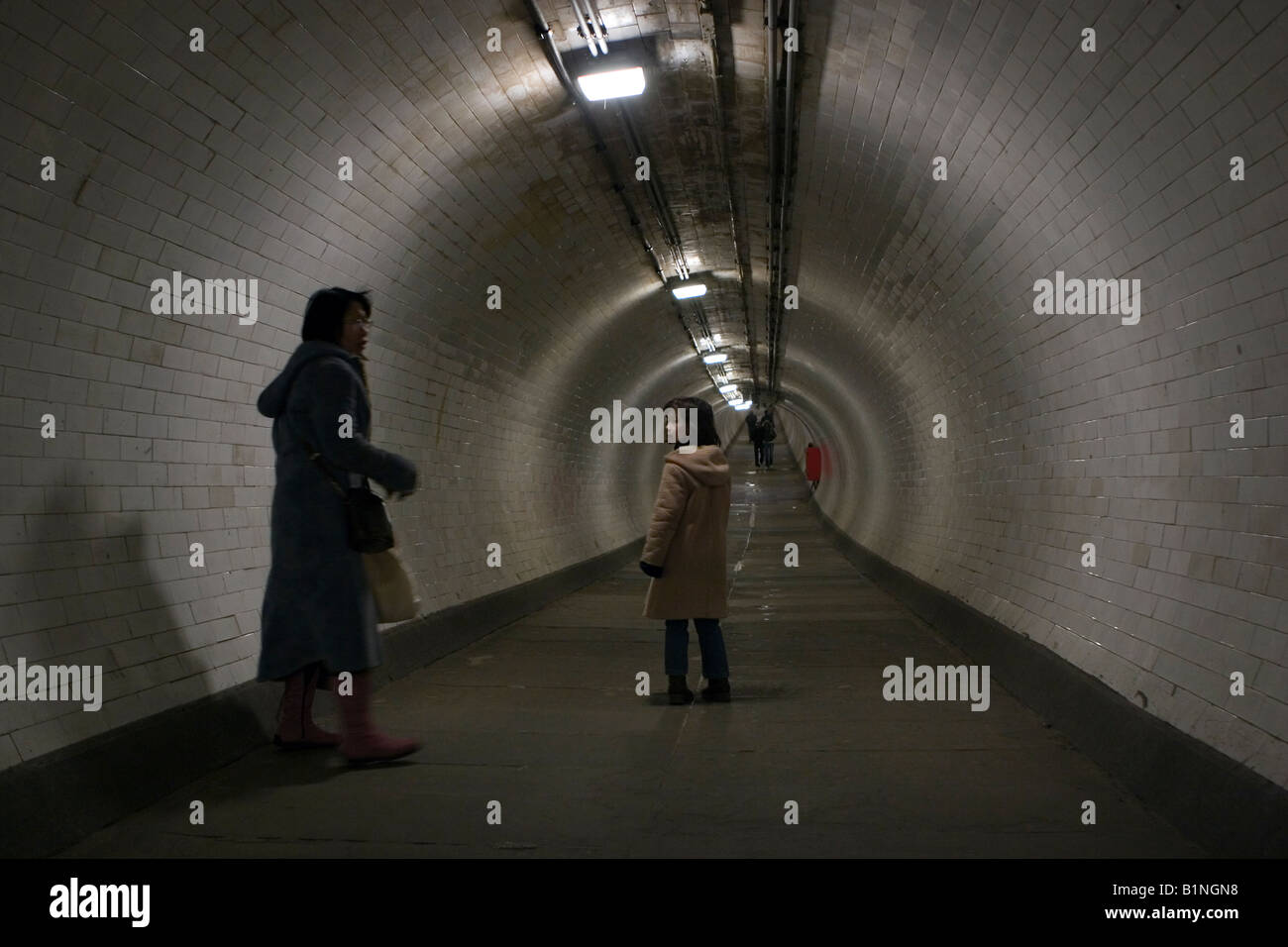Mother and child in the Thames Foot Tunnel which runs from Greenwich to the Isle of Dogs in London Stock Photo