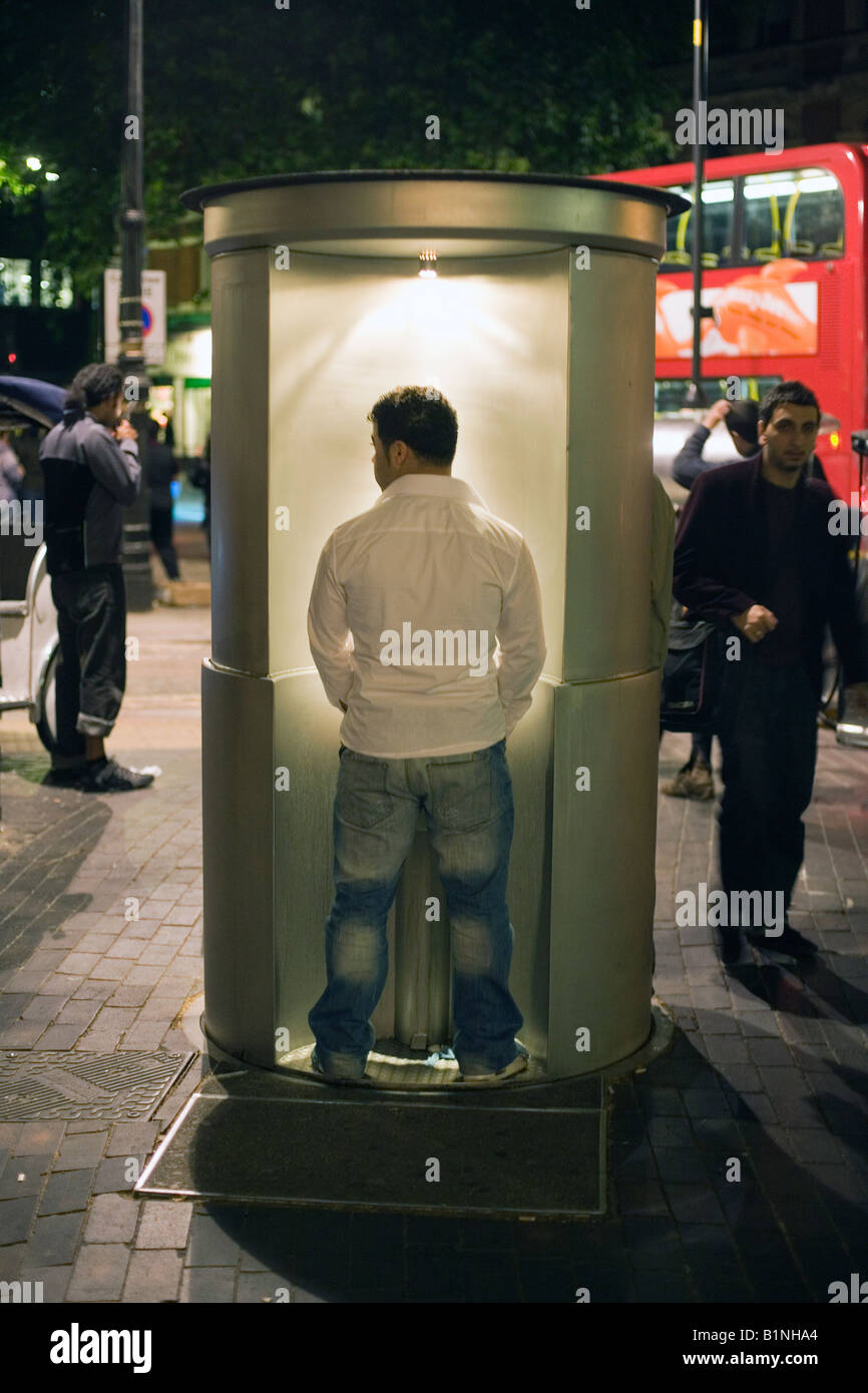 a man using a public urinal in cambridge circus, london Stock Photo Alamy