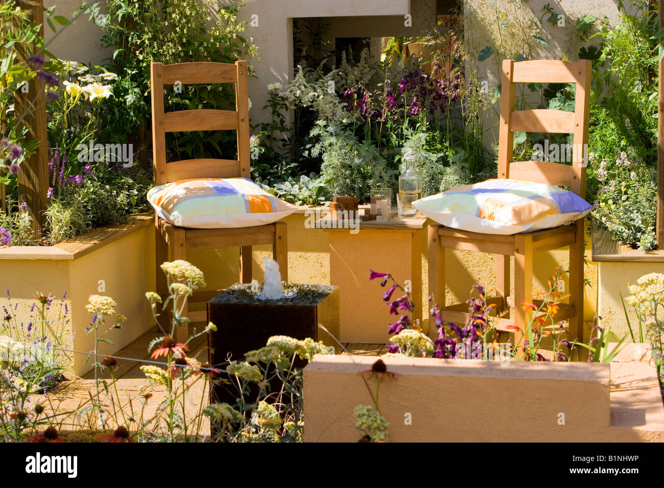 2 wooden chairs on a garden patio Stock Photo - Alamy