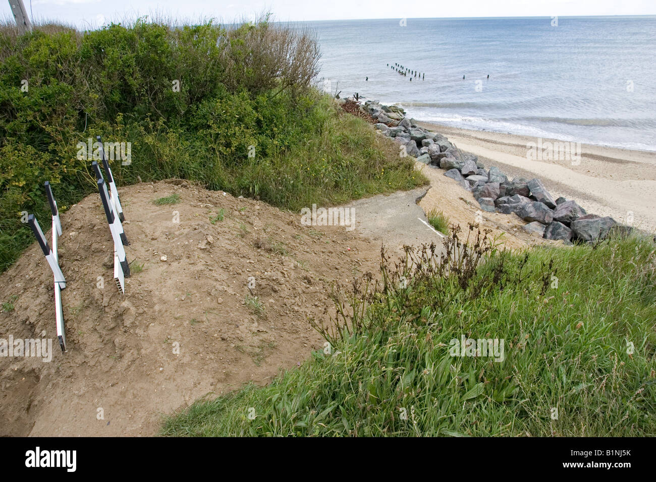 Collapsed road after severe coastal erosion Happisburgh North Norfolk Coast UK Stock Photo