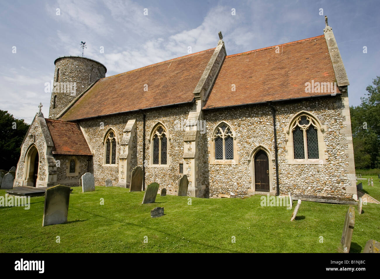 St Marys church with round stone tower Burnham Deepdale Norfolk UK Stock Photo