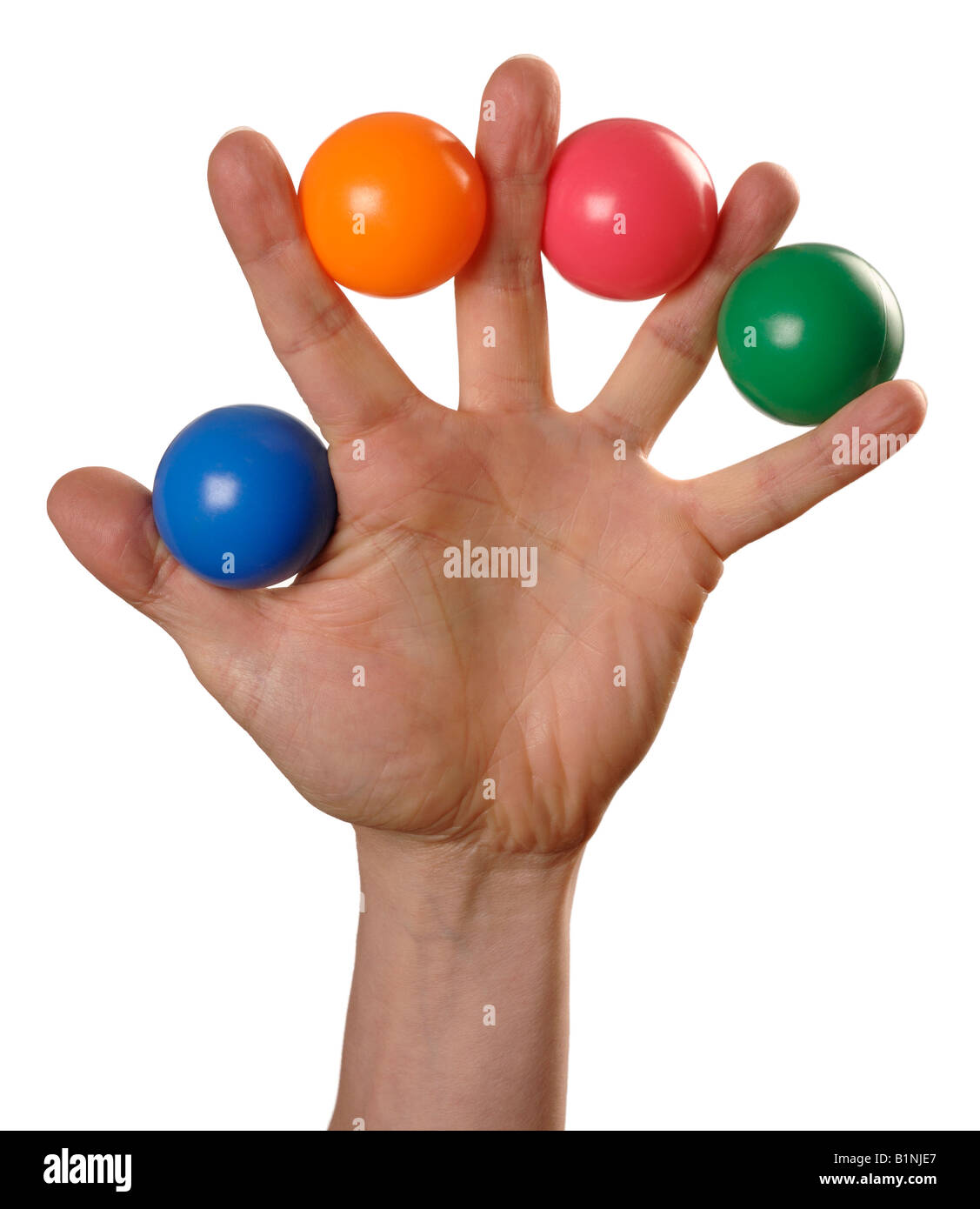 Mans hand holding coloured plastic balls Stock Photo