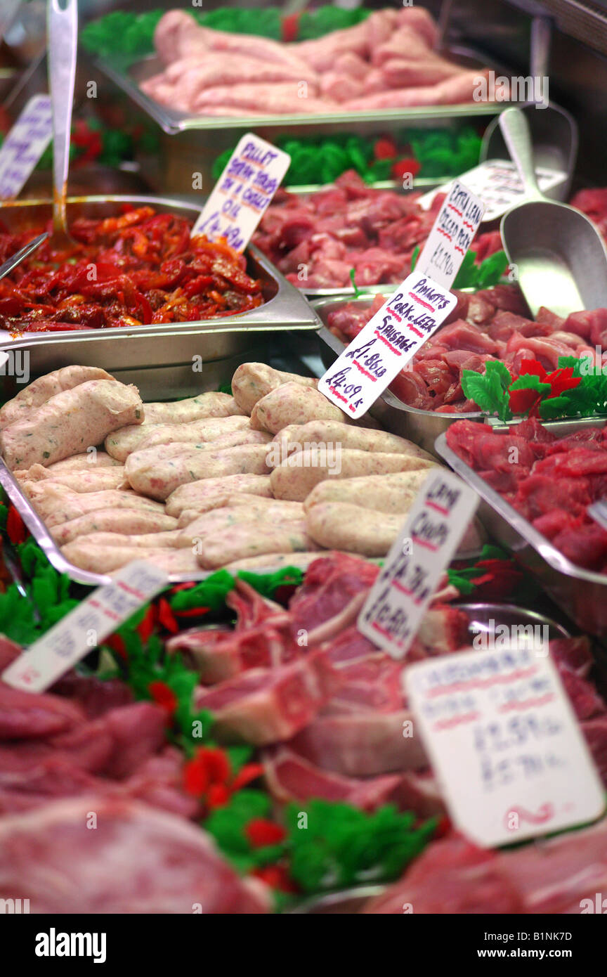 Trays of raw meat in butchers display Stock Photo Alamy