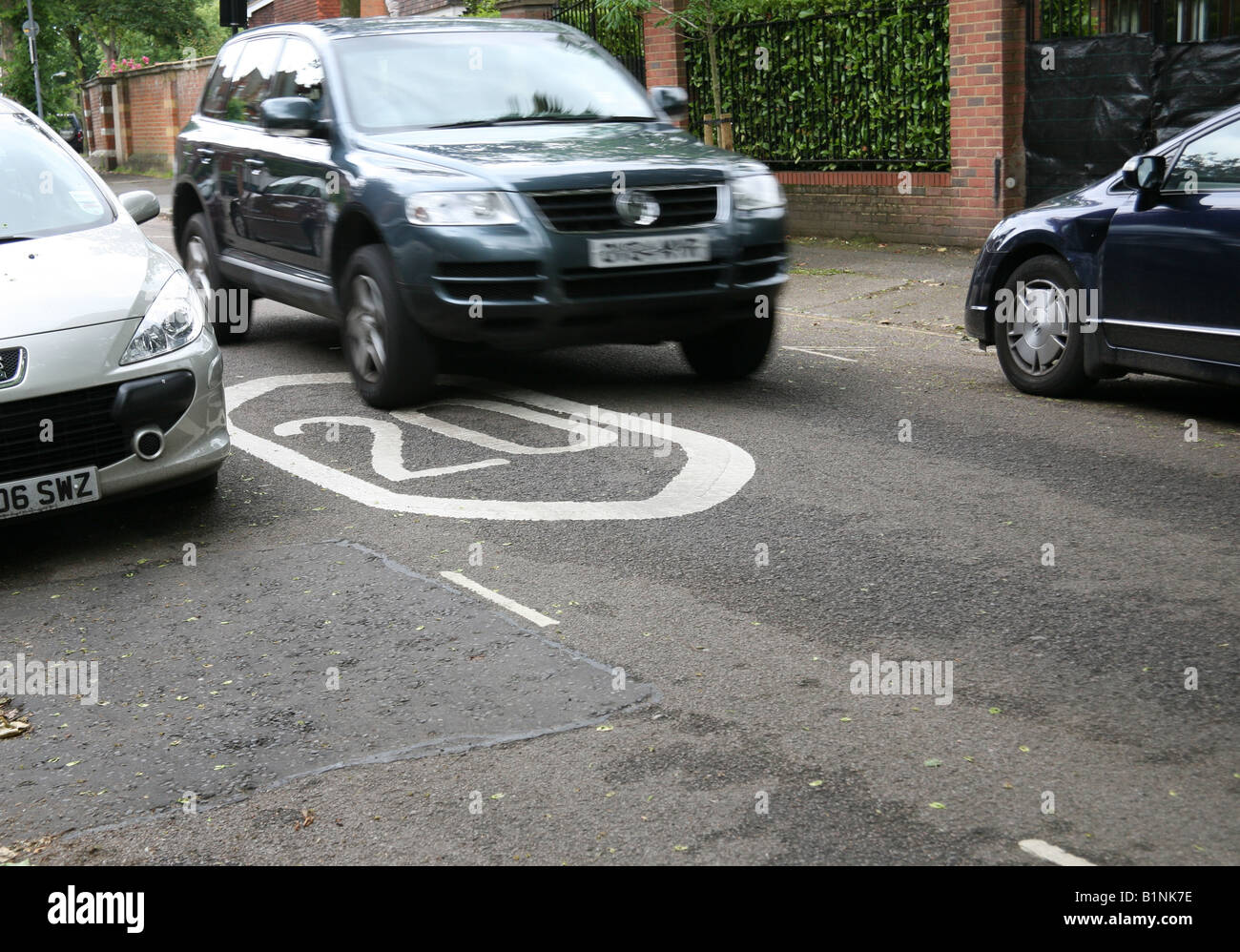Car goes over 20mph speed limit marking in London street Stock Photo