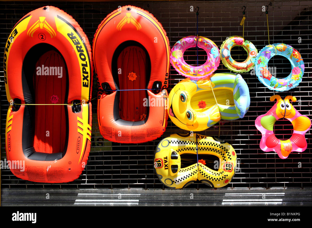 Inflatable beach toys on display outside shop, England Stock Photo