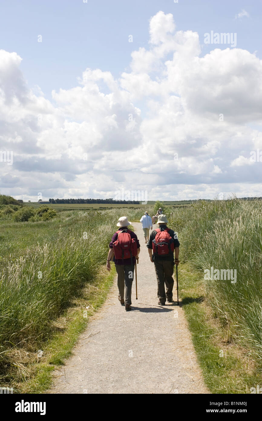 Two walkers birders RSPB Reserve Titchwell Marshes North Norfolk UK Stock Photo